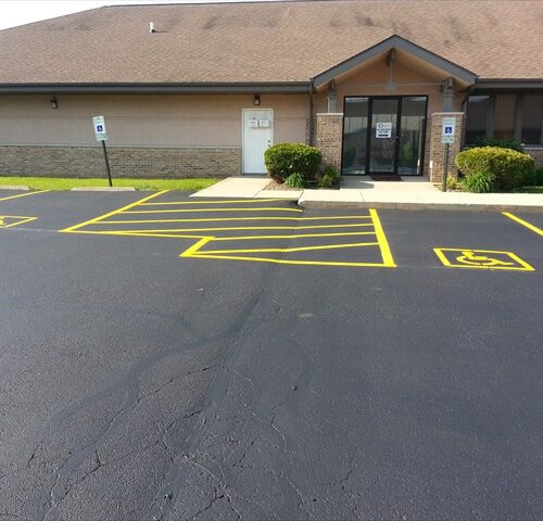 A parking lot with yellow lines on the ground.