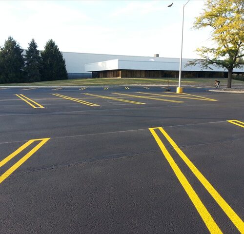 A parking lot with yellow lines painted on it.